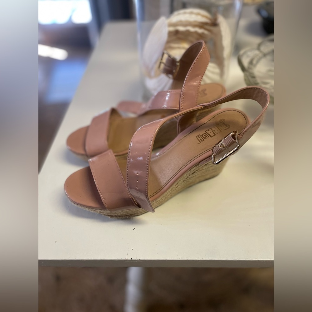 Woman’s tan wedges.